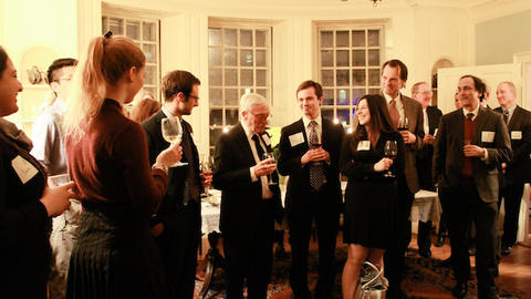 group of people drinking tea and mingling