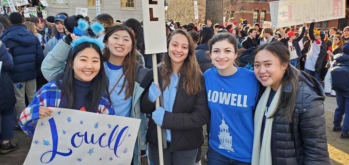 A group of Lowellians wearing blue smile for Housing Day