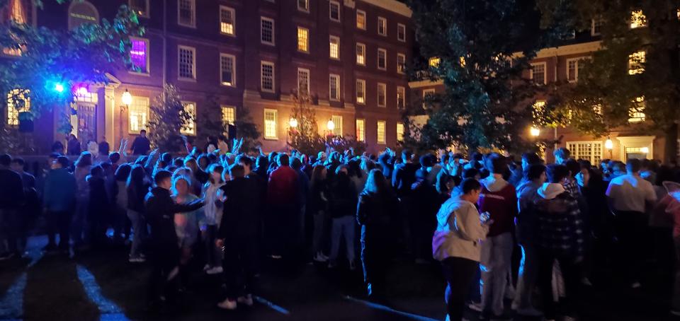 Students celebrating Glowell in neon lighting in the large courtyard