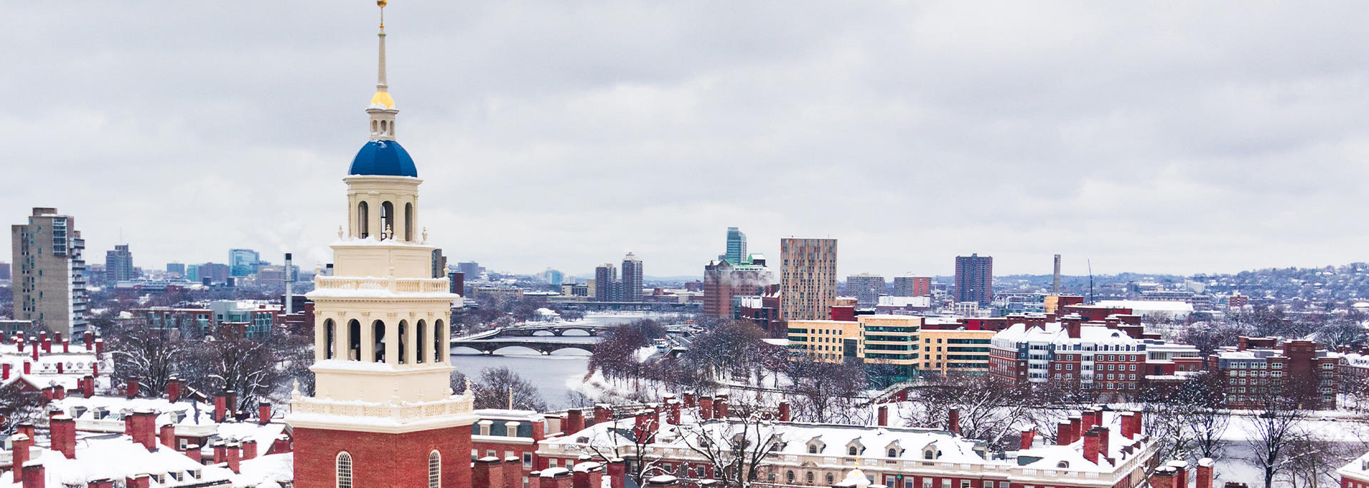 Lowell House from bird's eye covered in white snow on a grey winter day.