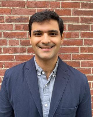 man with a blue jacket smiling 